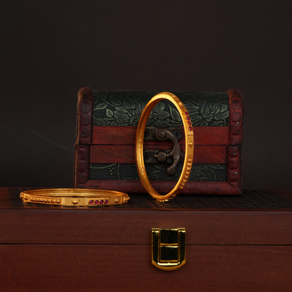 Sleek Geometric Gold Bangle with Ruby Cluster Detailing
